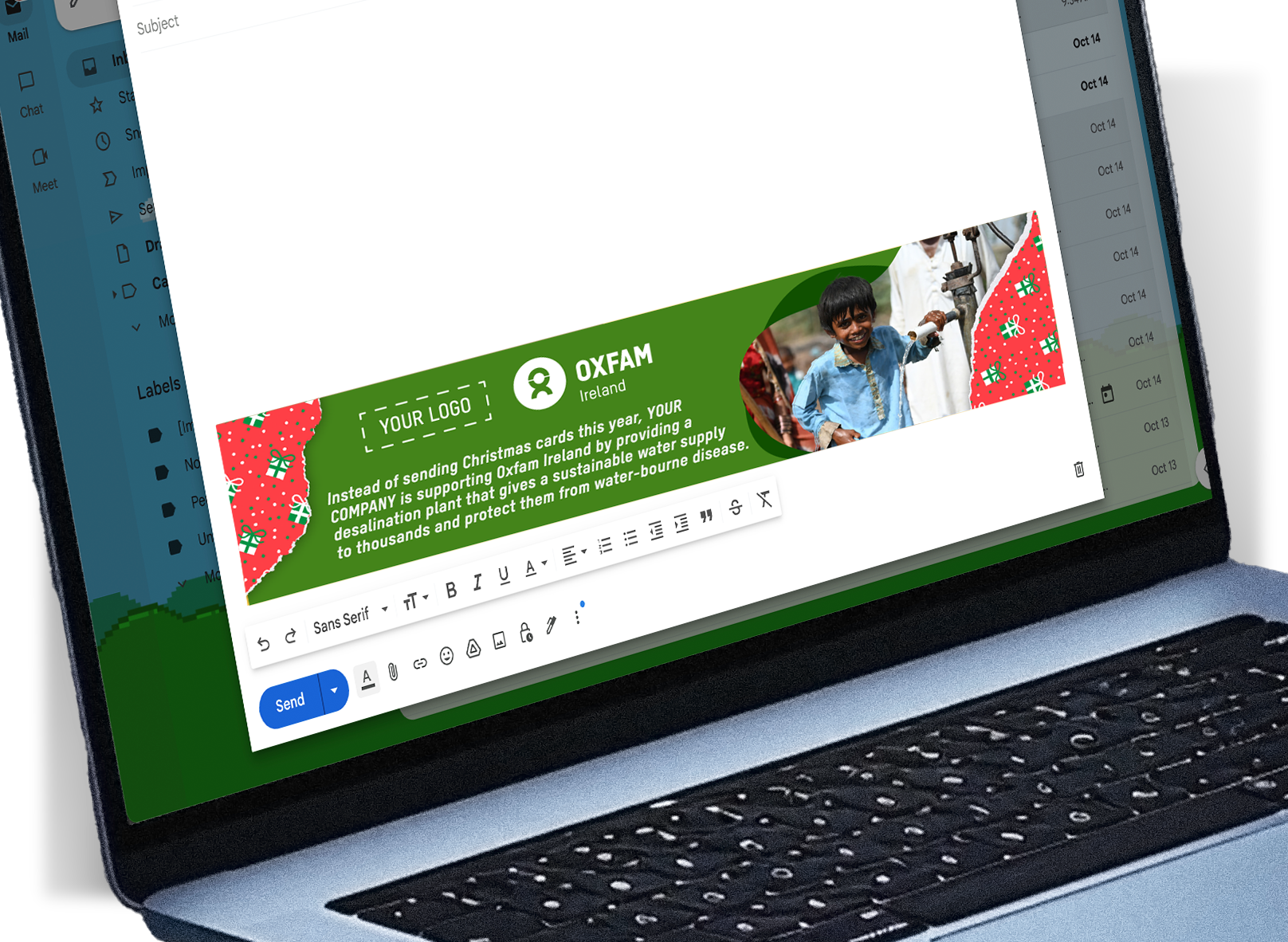 Image of a laptop with a new email open on the screen. You can see the Oxfam Corporate Unwrapped footer. The footer is festive blue and and red highlighting the impact your gift has.