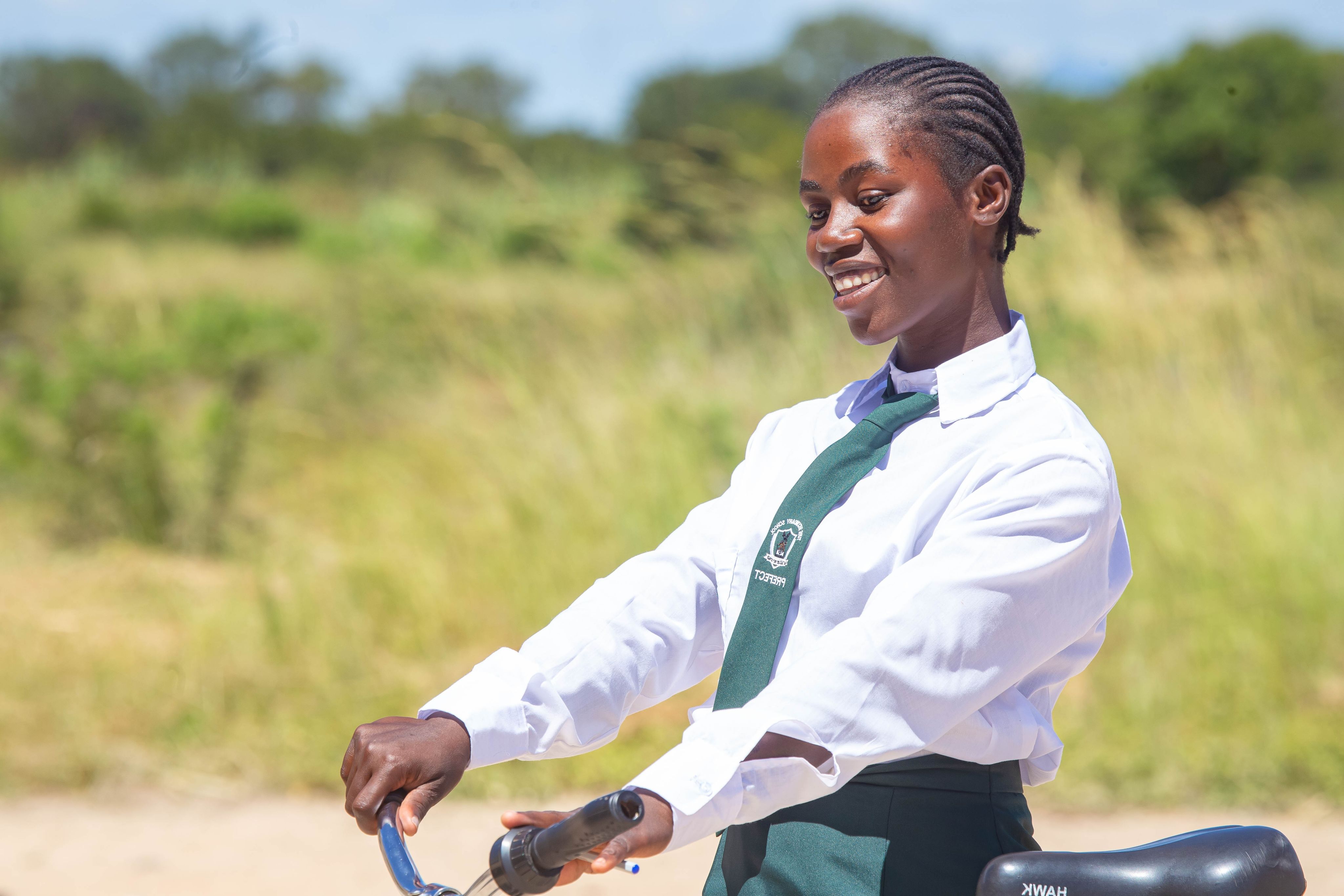 Beata on her bike ready to go to school in Zimbabwe